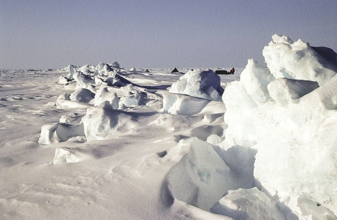 pale arctic sea ice meeting open ocean water at the floe edge